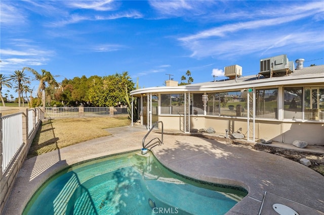 view of swimming pool with a patio and a sunroom