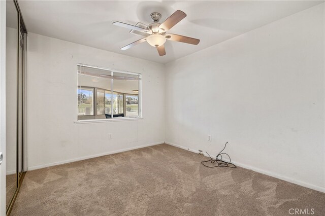 unfurnished room featuring light colored carpet and ceiling fan