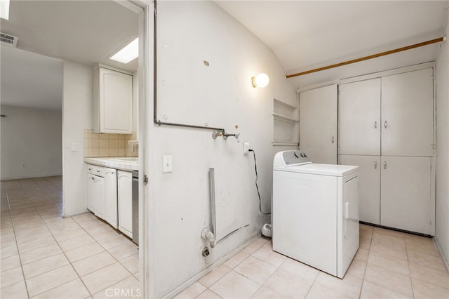 laundry area featuring visible vents, washer / dryer, cabinet space, and light tile patterned floors