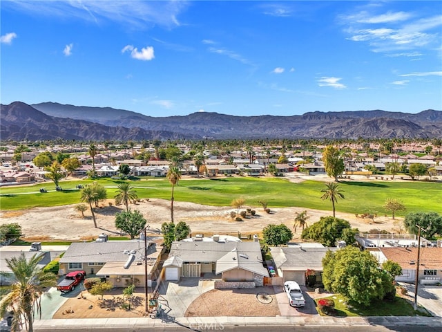 drone / aerial view with a residential view, a mountain view, and view of golf course