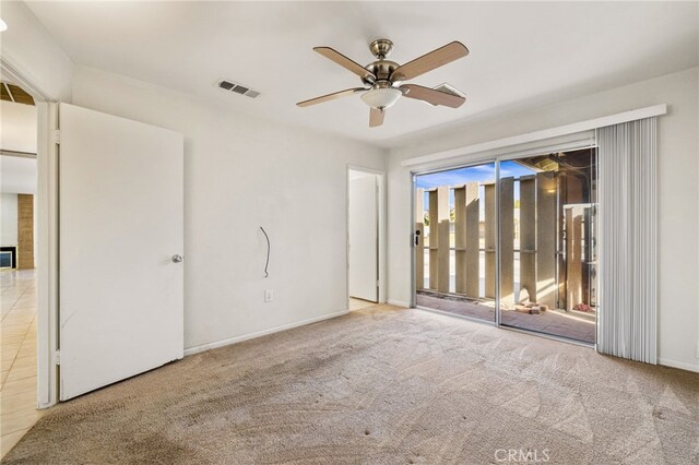 spare room featuring light carpet and ceiling fan