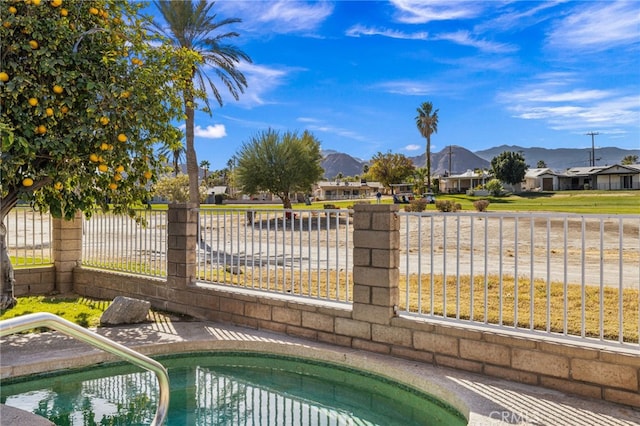 view of swimming pool featuring a swimming pool, a mountain view, a residential view, and fence