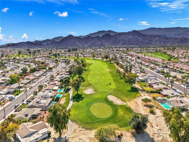 bird's eye view with view of golf course, a residential view, and a mountain view