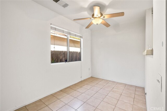 tiled empty room with ceiling fan