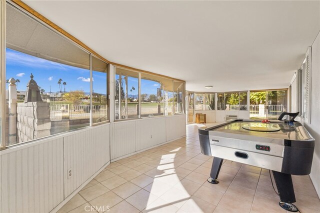 rec room featuring tile patterned floors and plenty of natural light