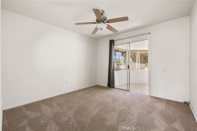 empty room featuring light carpet and ceiling fan