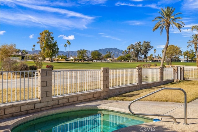 view of swimming pool featuring a fenced in pool, a mountain view, and fence