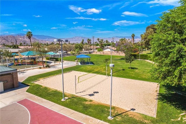 view of community with volleyball court, a lawn, a gazebo, and a mountain view