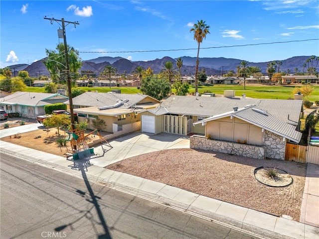 exterior space featuring a mountain view, fence, a residential view, and a gate