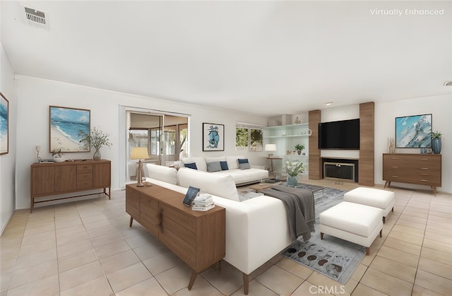 living room featuring a large fireplace and light tile patterned floors