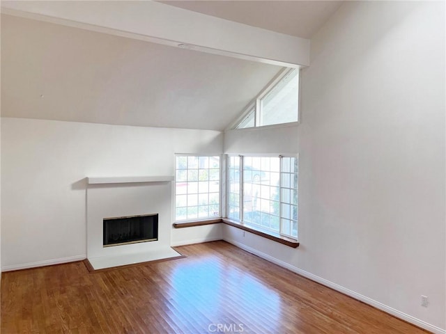 unfurnished living room featuring lofted ceiling and wood-type flooring