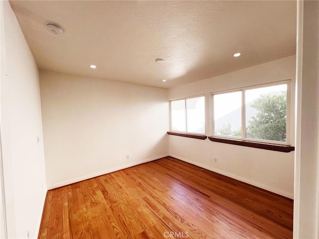 unfurnished room with light hardwood / wood-style flooring