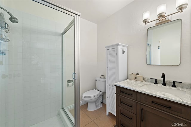 bathroom featuring vanity, tile patterned floors, toilet, and walk in shower