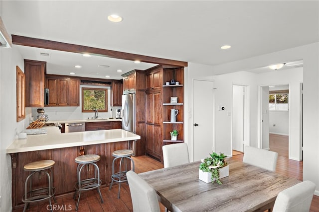 dining space featuring sink and wood-type flooring