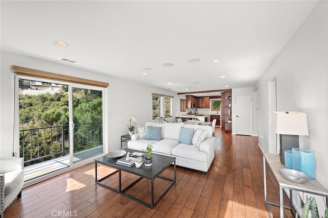 living room featuring plenty of natural light and dark hardwood / wood-style floors