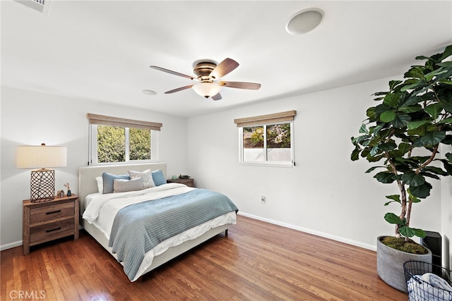 bedroom with ceiling fan and wood-type flooring