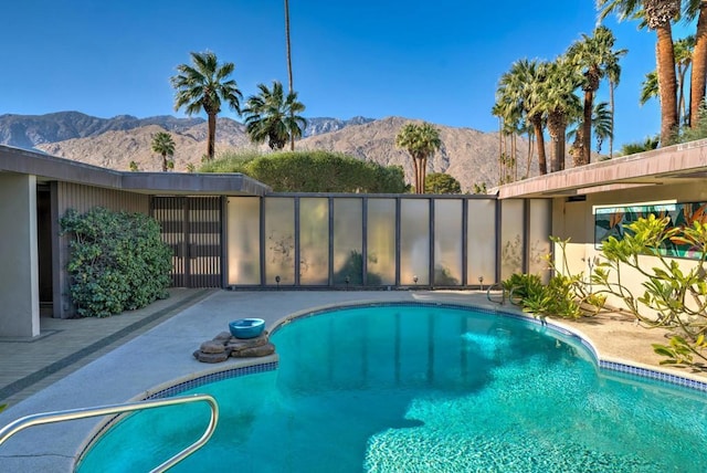 view of swimming pool featuring a mountain view