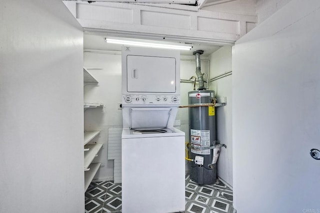 laundry area featuring stacked washer / drying machine and strapped water heater