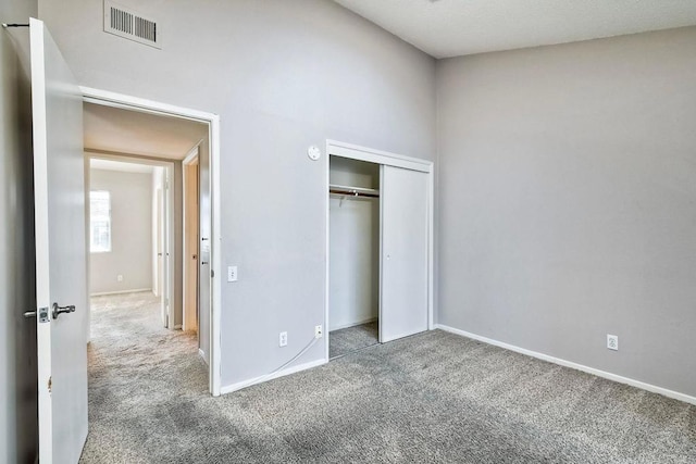 unfurnished bedroom with carpet floors and a closet