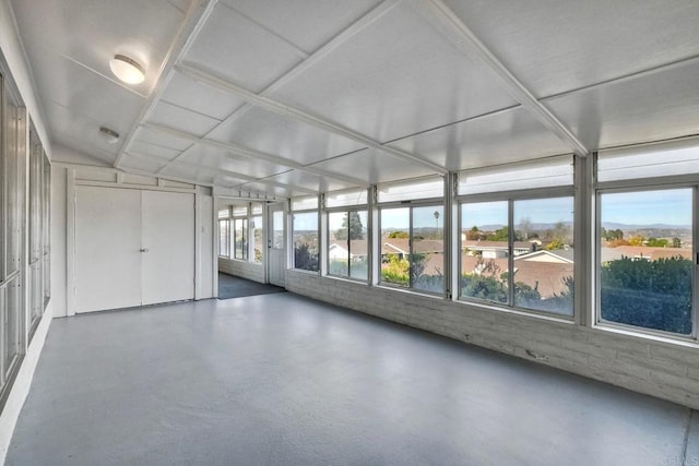 unfurnished sunroom with lofted ceiling and a wealth of natural light