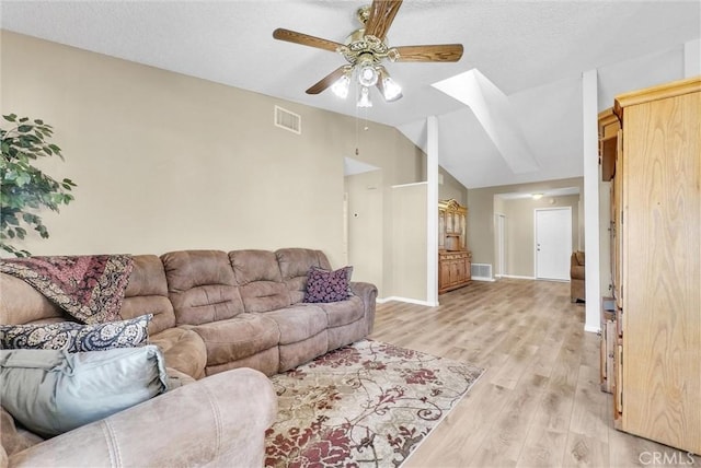 living room with light hardwood / wood-style flooring and ceiling fan