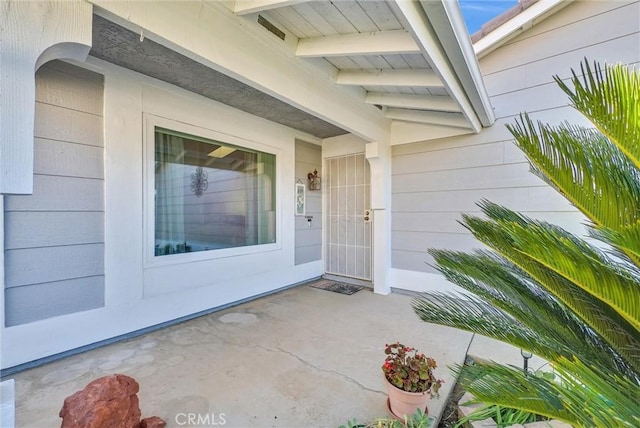 entrance to property featuring a patio area