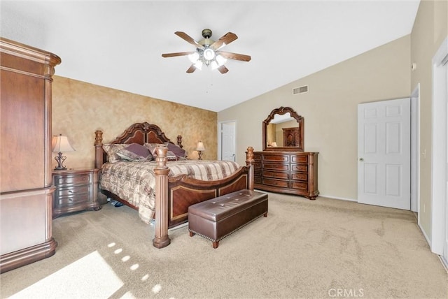 bedroom with ceiling fan, lofted ceiling, and light colored carpet