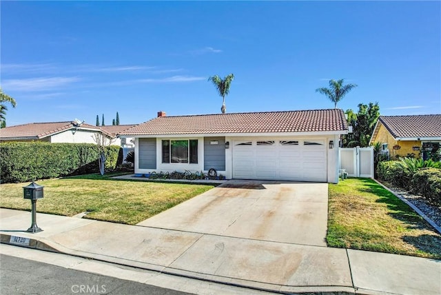 view of front of house featuring a garage and a front lawn