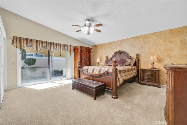 carpeted bedroom featuring access to exterior, a textured ceiling, vaulted ceiling, and ceiling fan