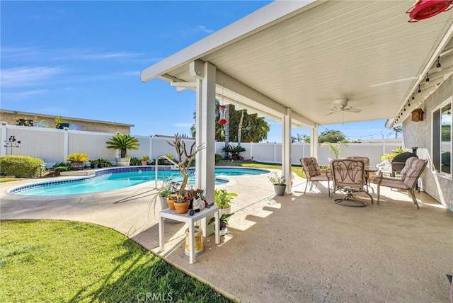 view of swimming pool featuring ceiling fan and a patio area