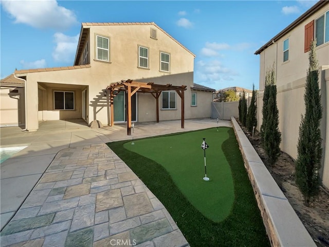 back of property with a pergola and a patio