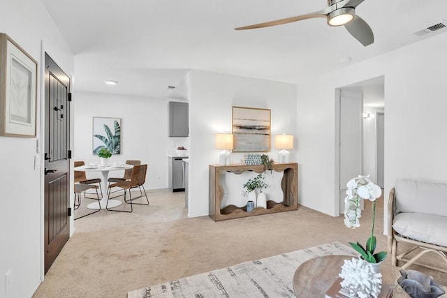 living room featuring light colored carpet and ceiling fan