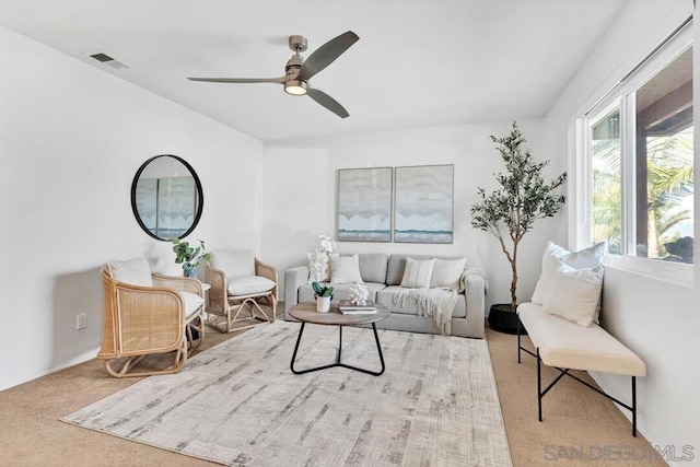 living room with ceiling fan and light carpet