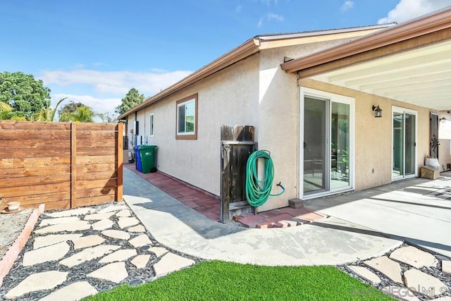 view of side of home with a patio