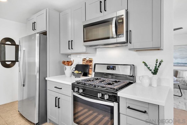 kitchen featuring light tile patterned flooring and stainless steel appliances