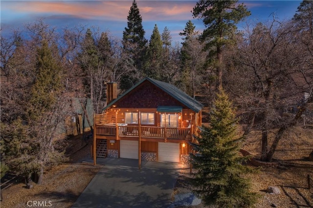 view of front of home featuring a wooden deck and a garage