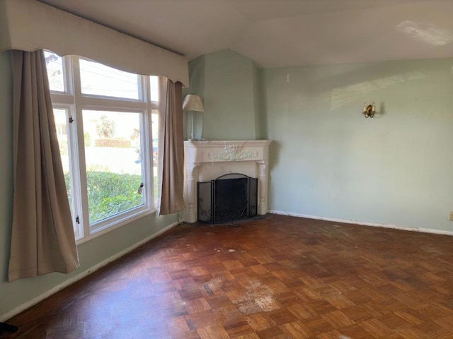 unfurnished living room with dark parquet flooring