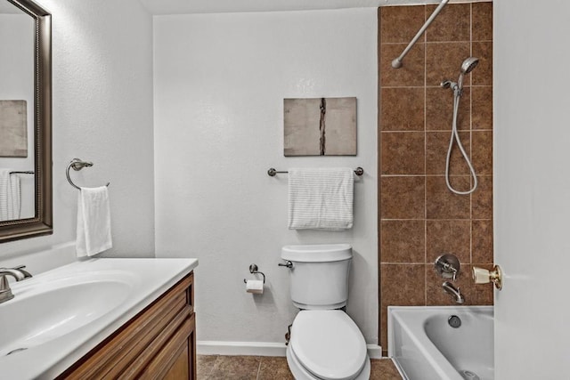 full bathroom featuring vanity, tiled shower / bath, tile patterned floors, and toilet