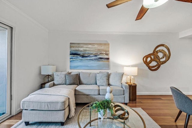 living room featuring a healthy amount of sunlight, hardwood / wood-style flooring, ornamental molding, and ceiling fan