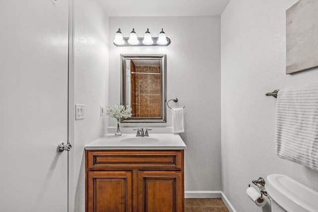 bathroom with vanity, tile patterned floors, and toilet