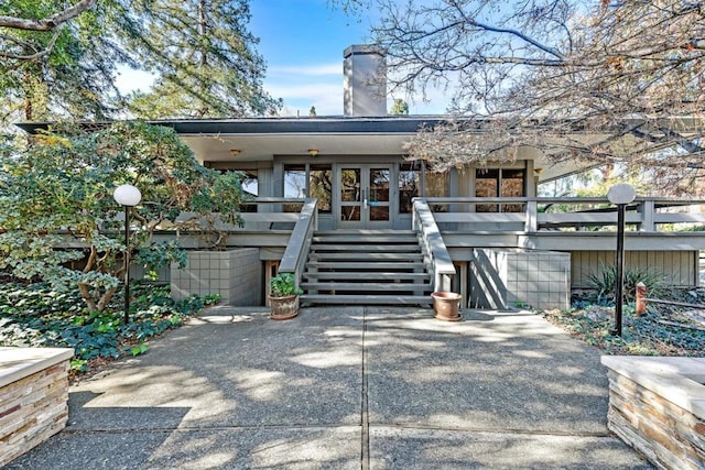 rear view of house featuring french doors