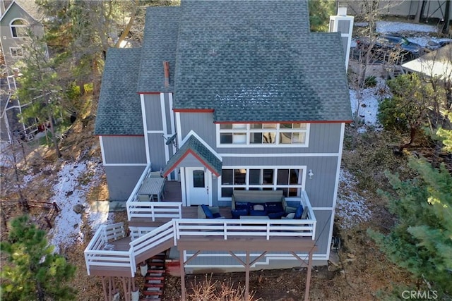 rear view of property with a wooden deck