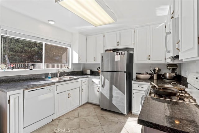 kitchen featuring white cabinetry, sink, and white appliances