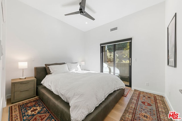 bedroom with lofted ceiling, access to outside, light hardwood / wood-style floors, and ceiling fan