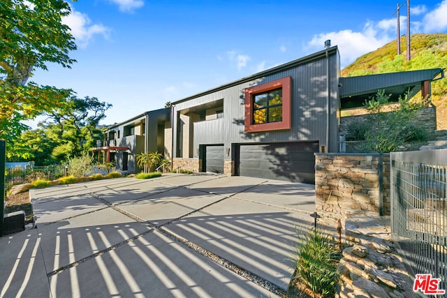 view of front of house featuring cooling unit and a garage