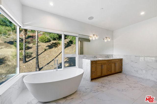 bathroom with vanity and a bath