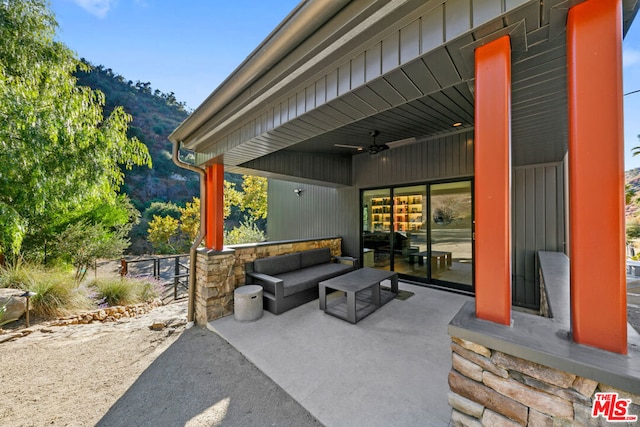 view of patio featuring a mountain view, outdoor lounge area, and ceiling fan