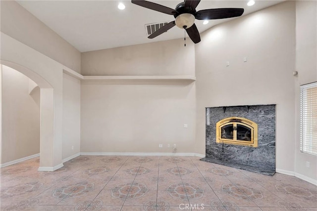 unfurnished living room featuring ceiling fan and a premium fireplace