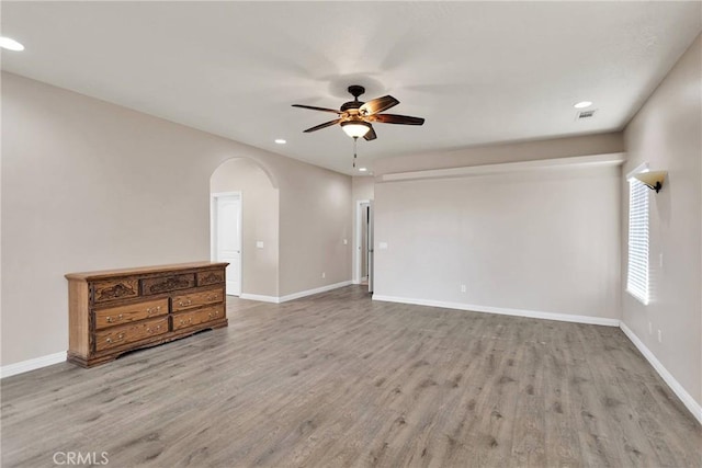 empty room featuring ceiling fan and light hardwood / wood-style floors