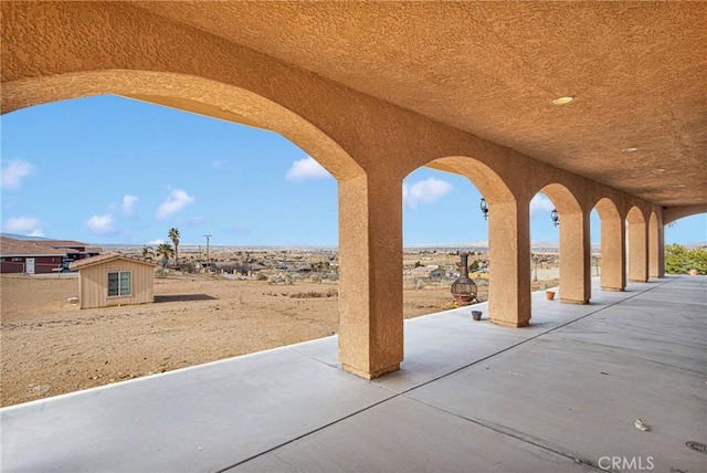 view of patio / terrace featuring a storage shed